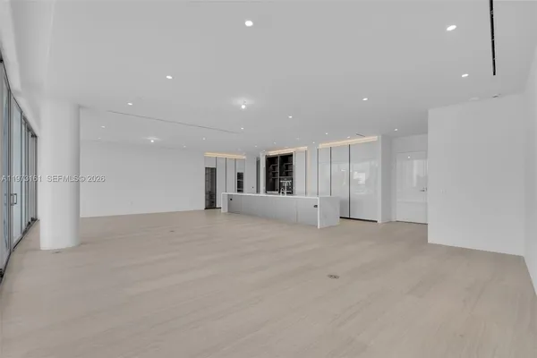 a dining hall with stainless steel appliances granite countertop a sink and a counter top space