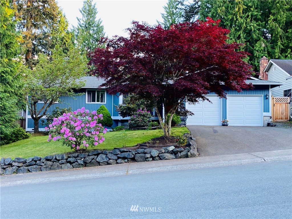 318 161st Place Southeast Bothell, WA 98012 - Photo 1 of 24 a front view of a house with a yard and fountain