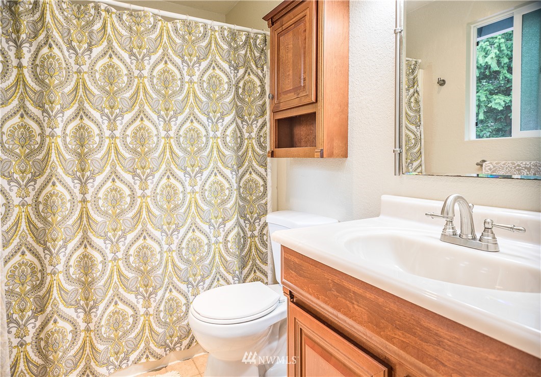 318 161st Place Southeast Bothell, WA 98012 - Photo 16 of 24 a bathroom with a sink a toilet and a mirror