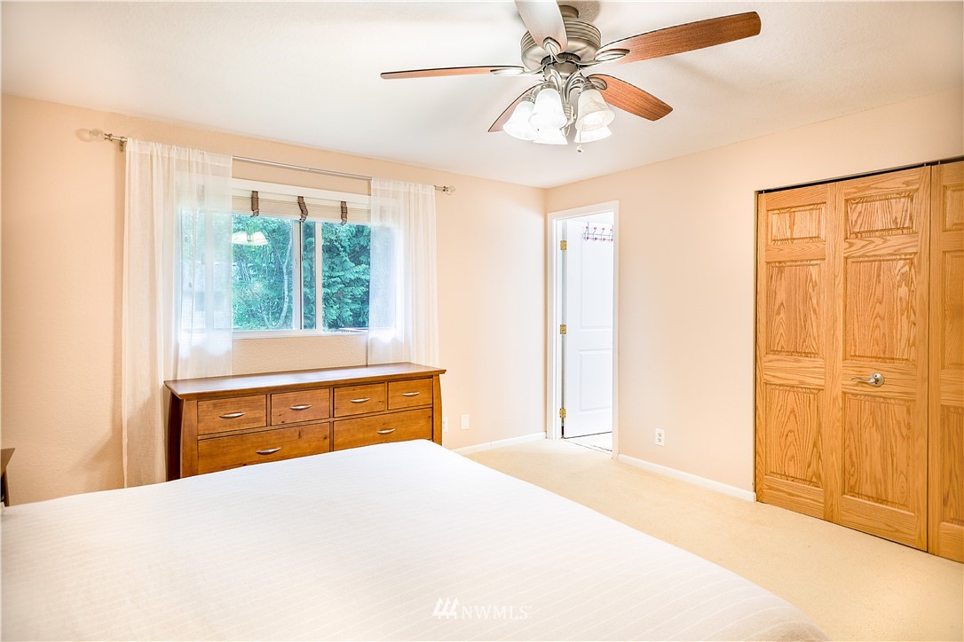 318 161st Place Southeast Bothell, WA 98012 - Photo 20 of 24 a bedroom with a bed and a chandelier