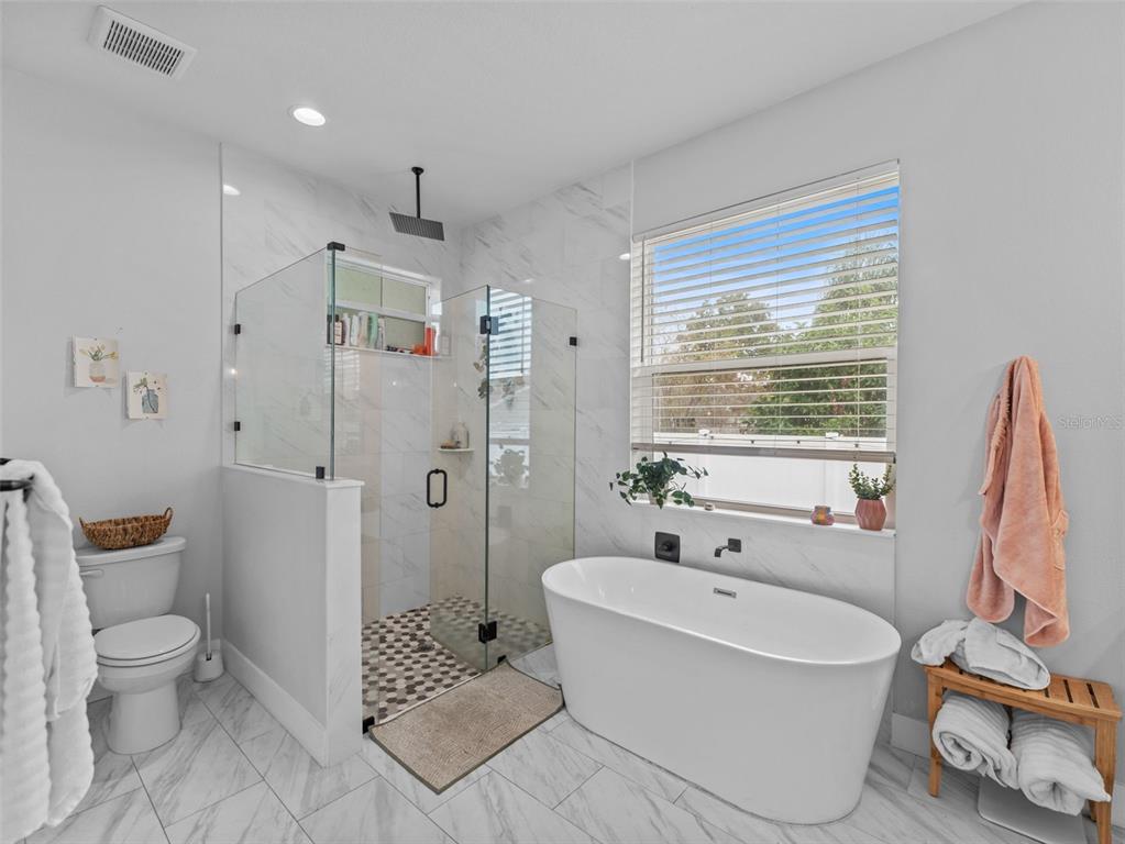 3103 West Leroy Street Tampa, FL 33607 - Photo 12 of 29 a bathroom with a granite countertop sink a toilet and shower