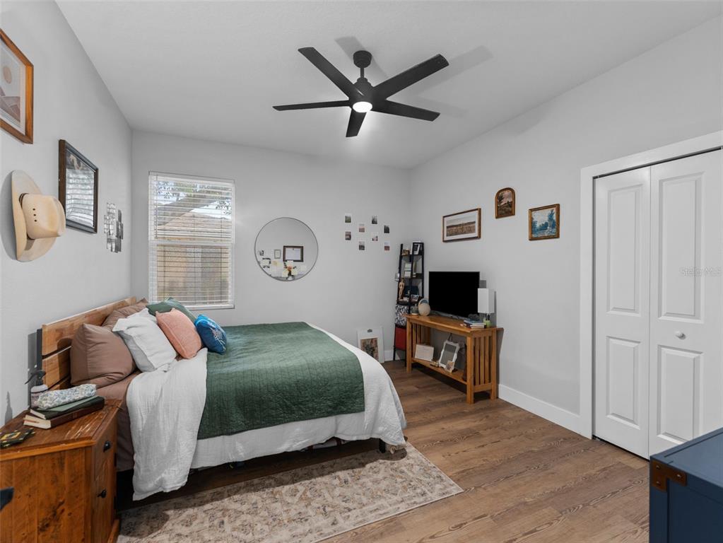 3103 West Leroy Street Tampa, FL 33607 - Photo 20 of 29 a bedroom with a bed and wooden floor
