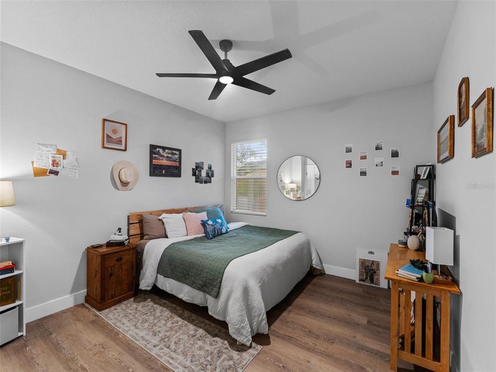 3103 West Leroy Street Tampa, FL 33607 - Photo 21 of 29 a bed room with a bed and a chandelier