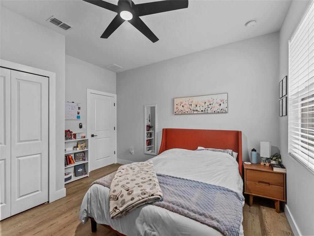 3103 West Leroy Street Tampa, FL 33607 - Photo 23 of 29 a bedroom with a bed and wooden floor