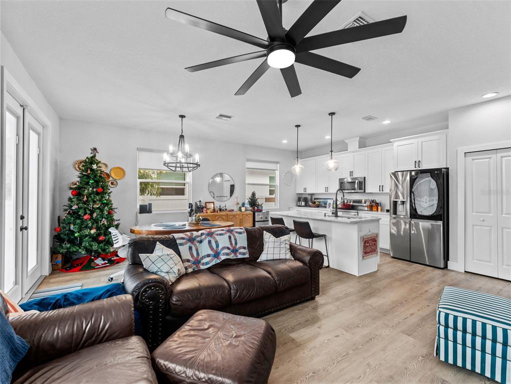 3103 West Leroy Street Tampa, FL 33607 - Photo 4 of 29 a living room with furniture kitchen and a chandelier