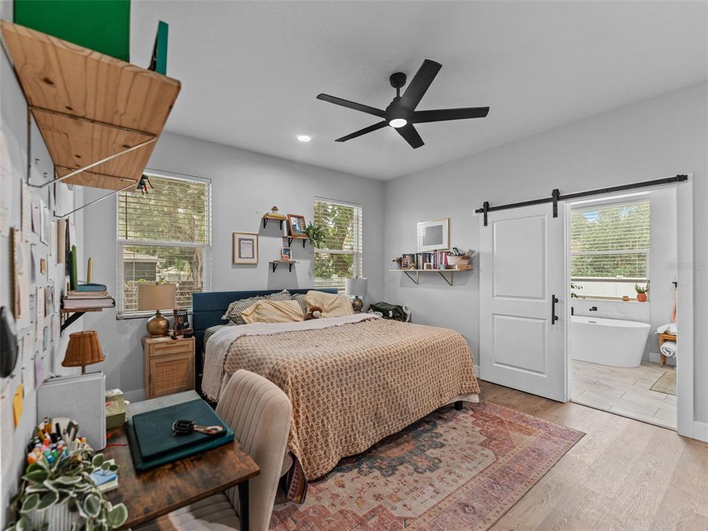 3103 West Leroy Street Tampa, FL 33607 - Photo 10 of 29 a bedroom with a bed and a chandelier