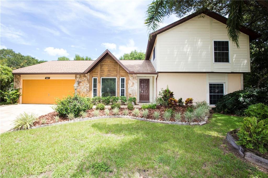 3041 Ridgevale Circle Brandon, FL 33511 - Photo 1 of 1 a front view of house with yard and green space