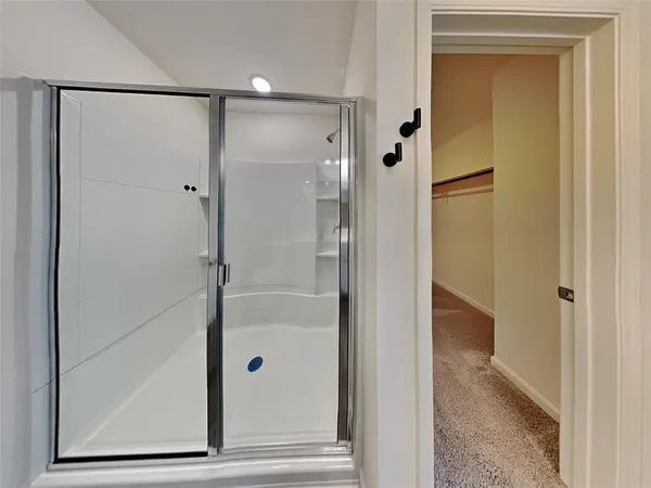 a bathroom with a glass shower door