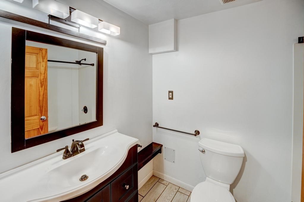 376 Great Road, Unit 15 Acton, MA 01720 - Photo 18 of 27 a bathroom with a sink mirror vanity and toilet