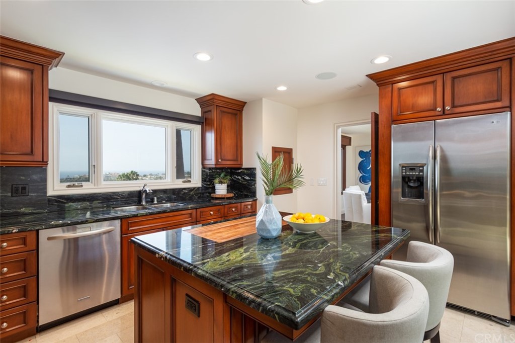 434 Emerald Bay Laguna Beach, CA 92651 - Photo 12 of 39 a kitchen with stainless steel appliances granite countertop a sink a stove and a refrigerator