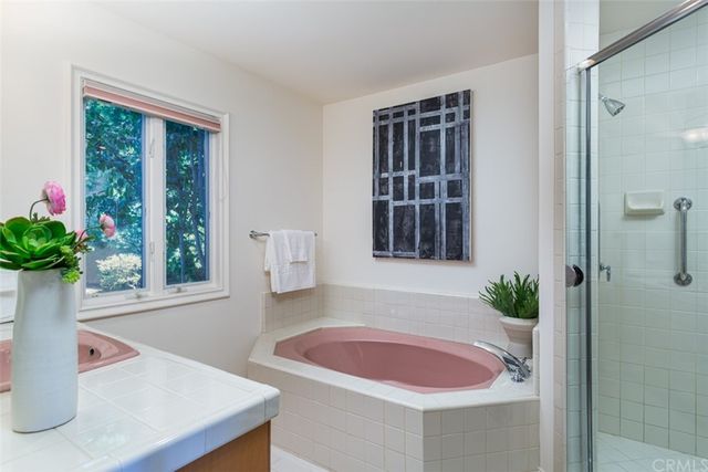 a bath room with a sink and a window