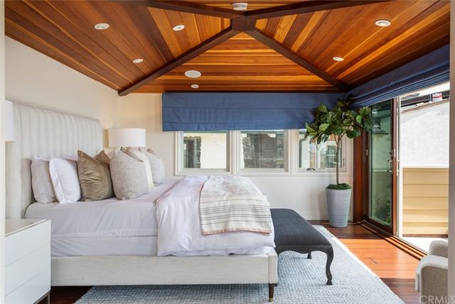 a bedroom with furniture and a large window