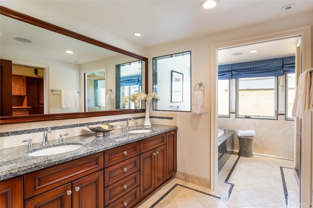 434 Emerald Bay Laguna Beach, CA 92651 - Photo 24 of 39 a spacious bathroom with a granite countertop sink and a mirror