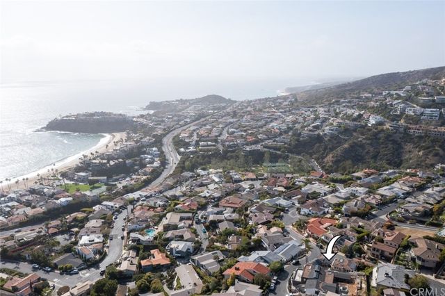 an aerial view of house with yard and mountain view in back