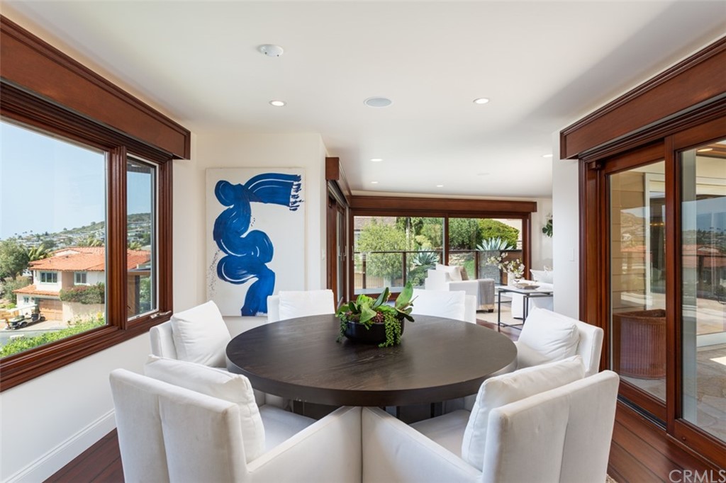 434 Emerald Bay Laguna Beach, CA 92651 - Photo 10 of 39 a view of a dining room with furniture large windows and wooden floor