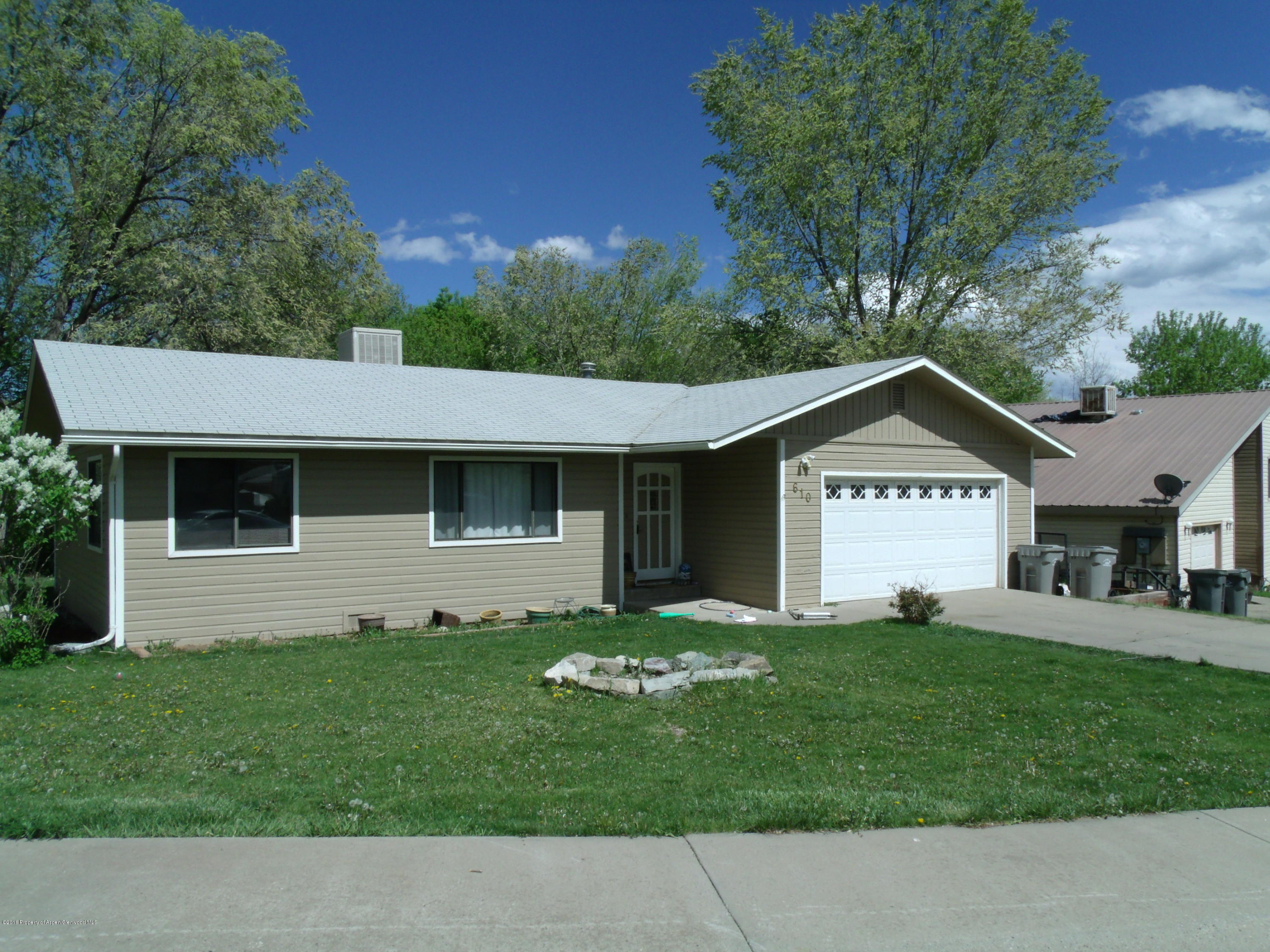 610 Ash Avenue Rifle, CO 81650 - Photo 1 of 18 a view of a house with a yard and a large tree