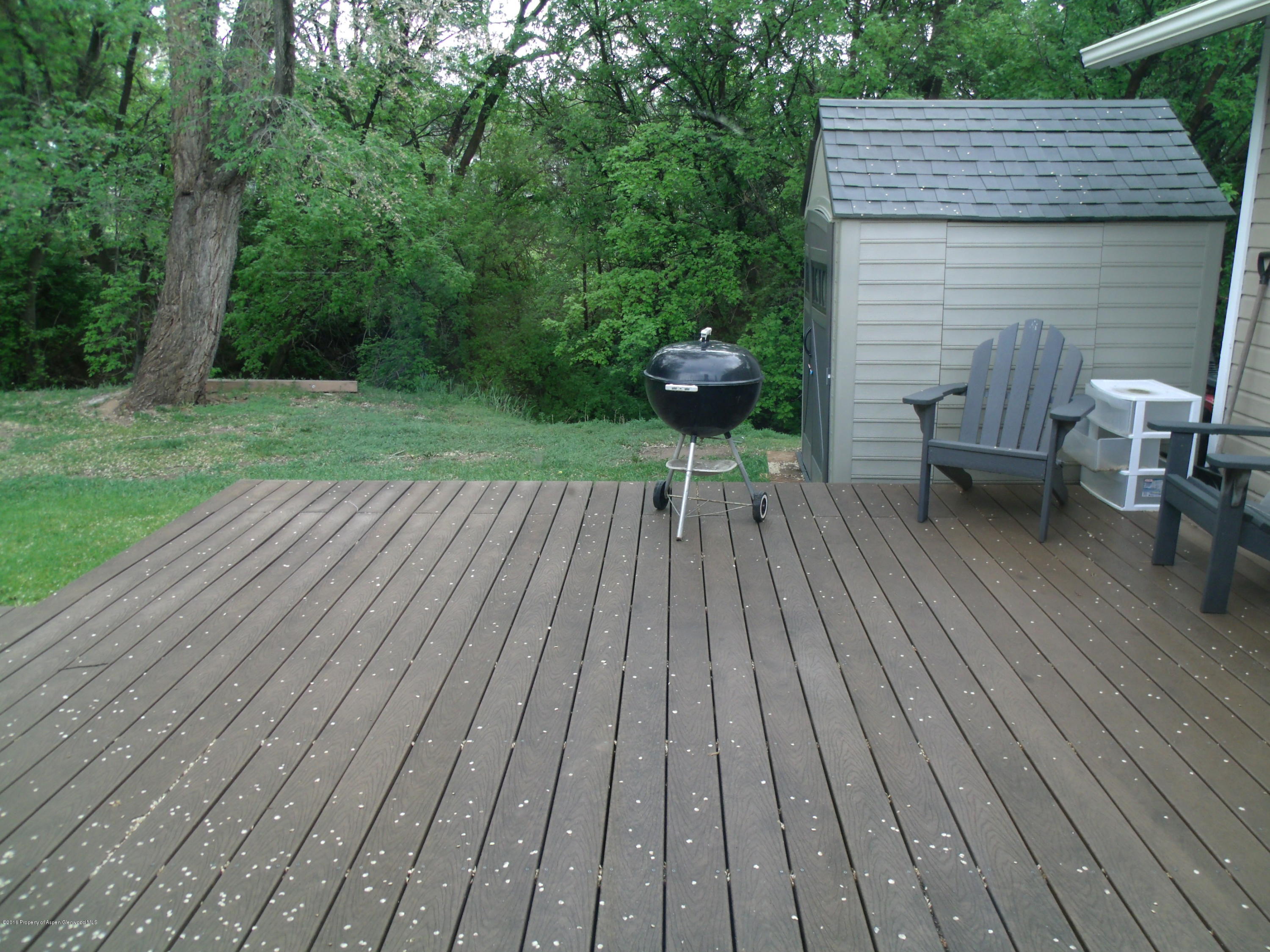 610 Ash Avenue Rifle, CO 81650 - Photo 14 of 18 a view of backyard with a table and chairs
