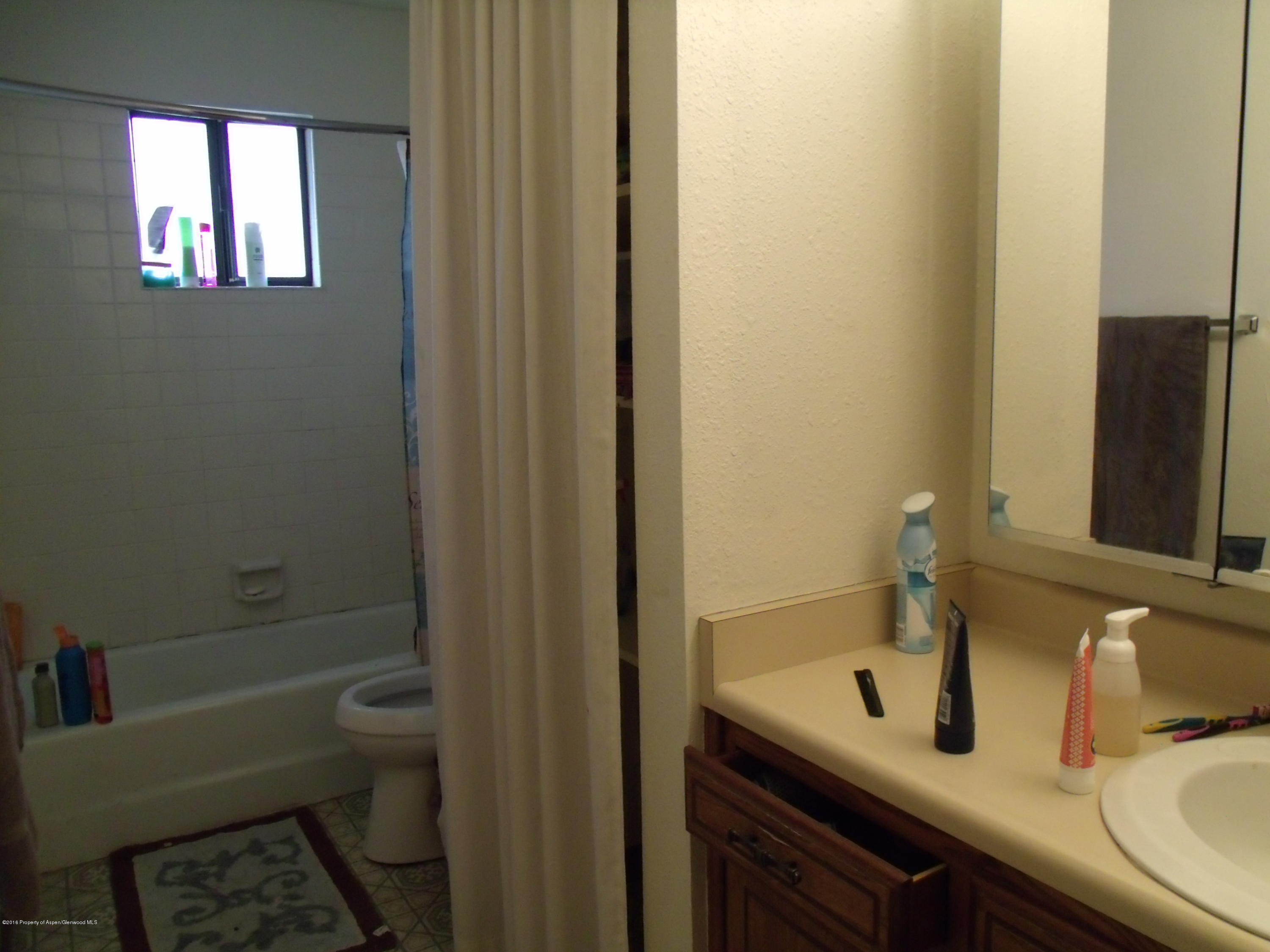 610 Ash Avenue Rifle, CO 81650 - Photo 15 of 18 a bathroom with a sink and a mirror