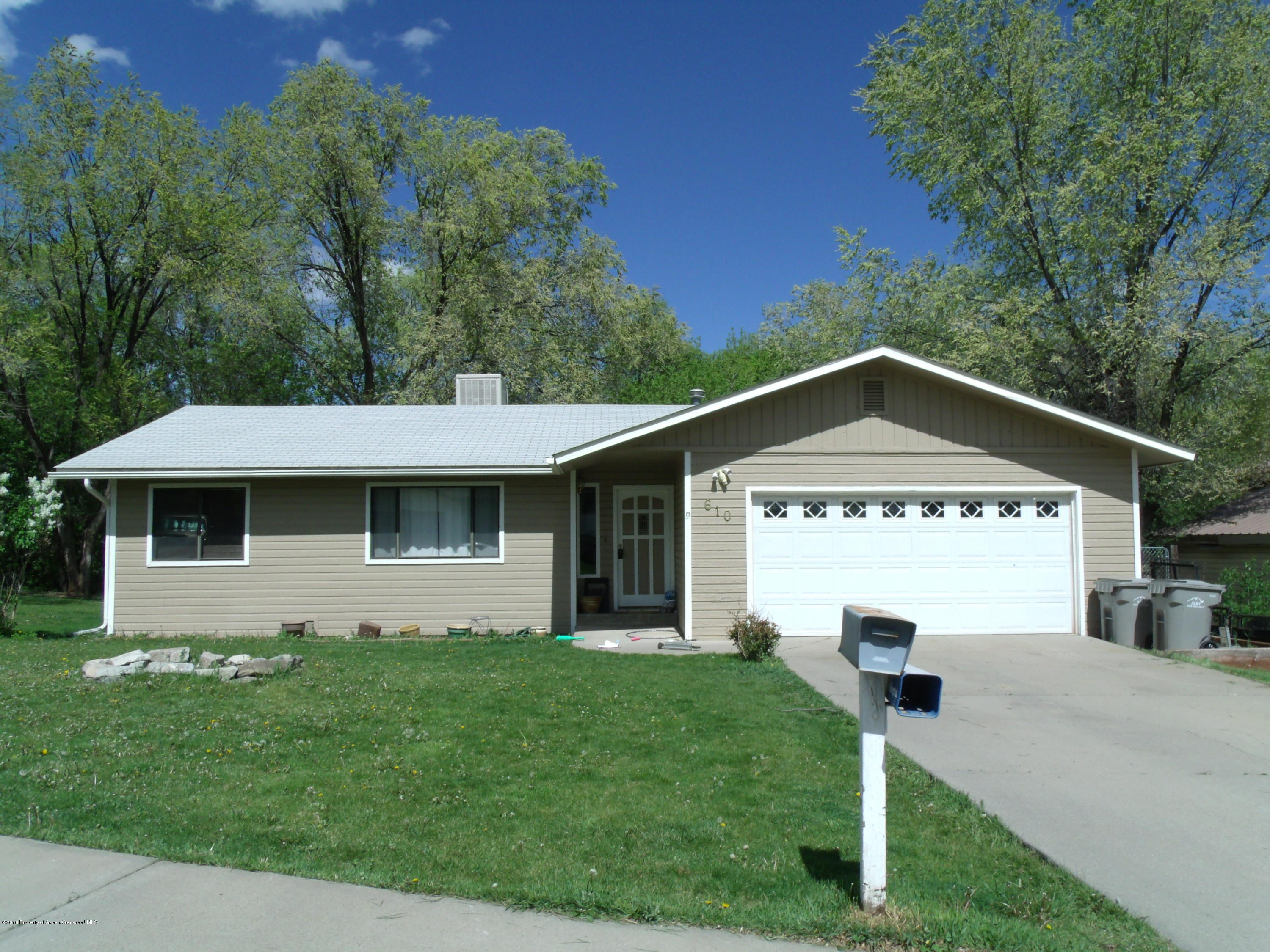 610 Ash Avenue Rifle, CO 81650 - Photo 2 of 18 a front view of a house with a yard