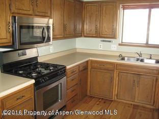 610 Ash Avenue Rifle, CO 81650 - Photo 5 of 18 a kitchen with a sink stove and microwave