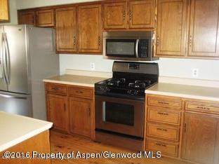 610 Ash Avenue Rifle, CO 81650 - Photo 7 of 18 a kitchen with granite countertop cabinets stainless steel appliances and a counter space