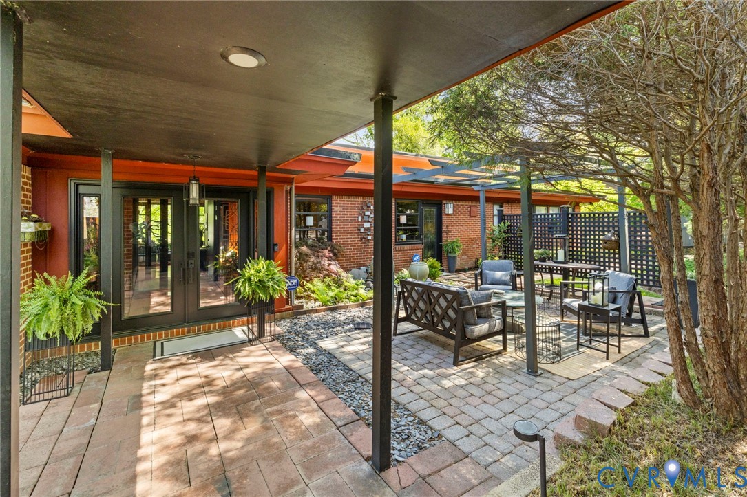 4904 Riverside Drive Richmond, VA 23225 - Photo 2 of 42 a view of a patio with table and chairs and potted plants