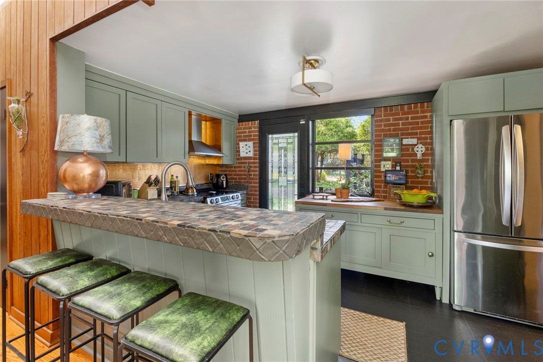 4904 Riverside Drive Richmond, VA 23225 - Photo 22 of 42 a kitchen with stainless steel appliances granite countertop a stove refrigerator and a sink