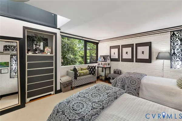 a living room with furniture lamp and large window