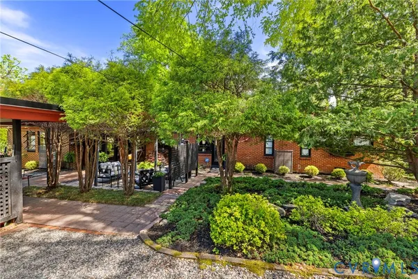 a front view of a house with a tree
