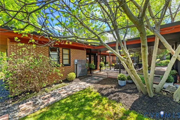 a view of a house with backyard and sitting area