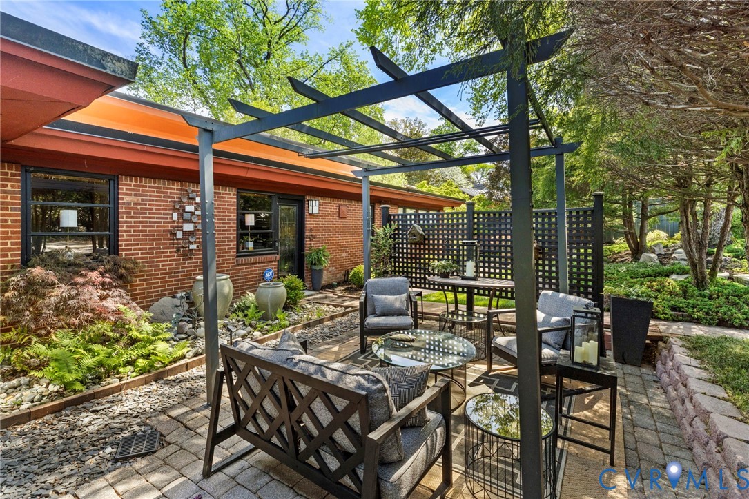 4904 Riverside Drive Richmond, VA 23225 - Photo 5 of 42 a view of a patio with table and chairs and potted plants