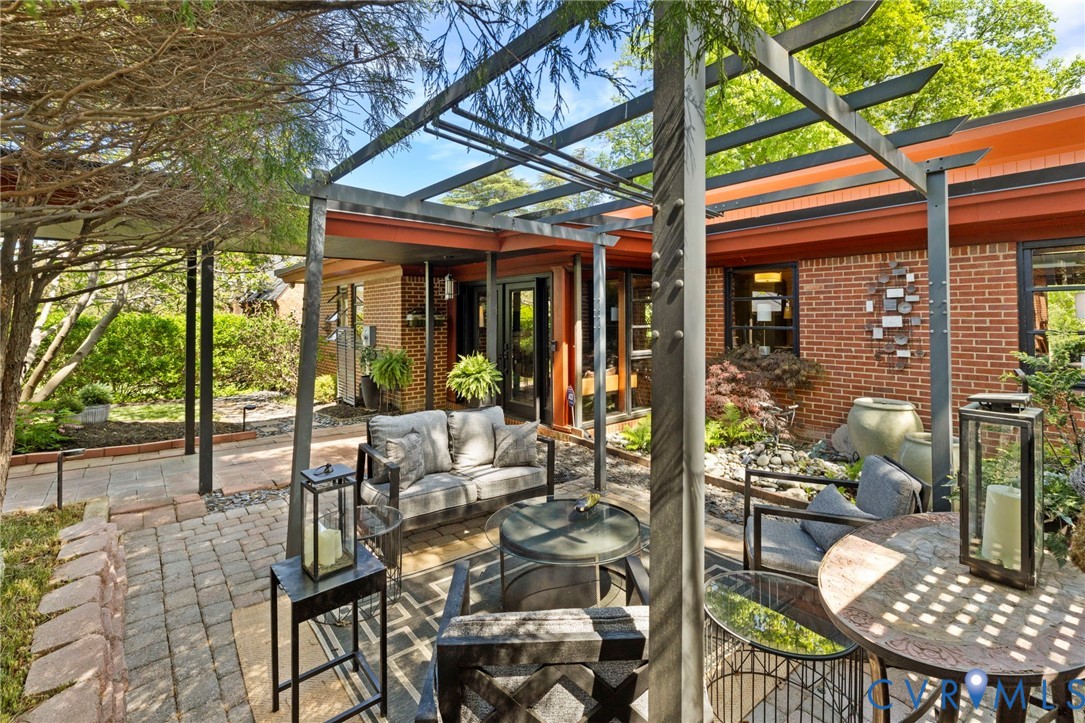 4904 Riverside Drive Richmond, VA 23225 - Photo 6 of 42 a view of a patio with a dining table and chairs