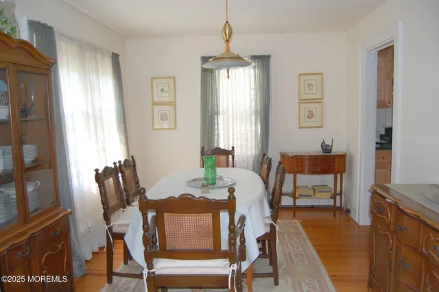 a living room with furniture a flat screen tv and a refrigerator