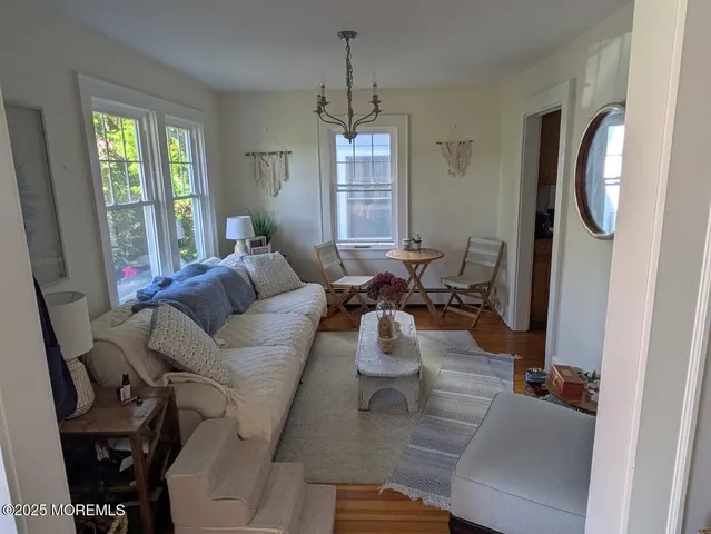 a living room with furniture and a chandelier