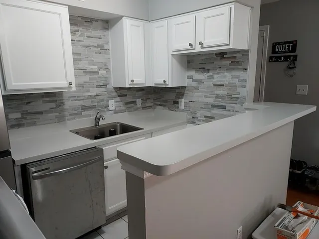 a kitchen with a sink and cabinets