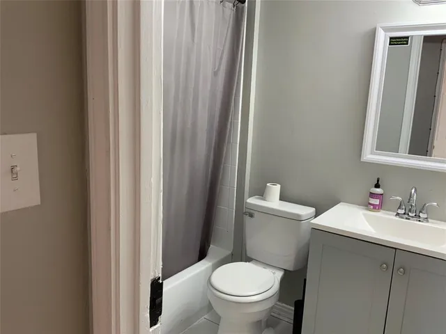 a white toilet sitting next to a bathroom sink