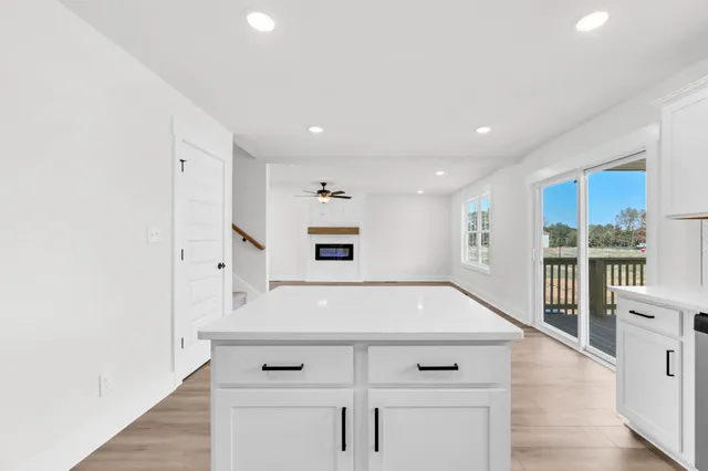 a view of kitchen with center island and wooden floor