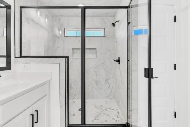a bathroom with a shower and a sink