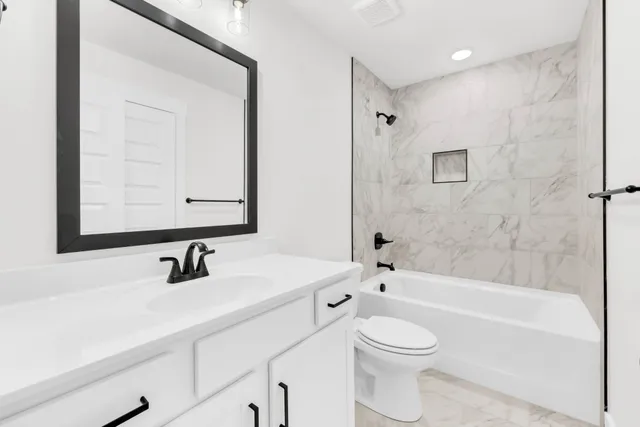 a bathroom with a sink a toilet and a mirror