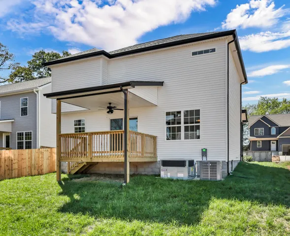 a view of backyard with a garden and deck