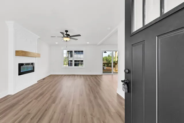 wooden floor in an empty room with a window