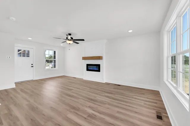 wooden floor in an empty room with a window