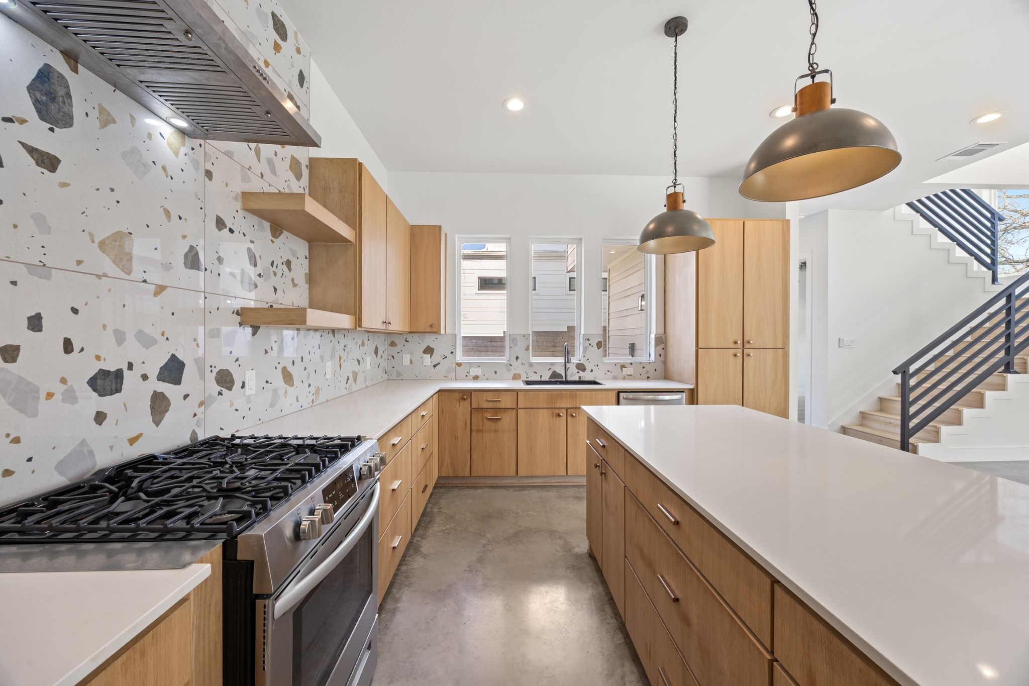 106 West Croslin Street, Unit 1 Austin, TX 78752 - Photo 11 of 31 a kitchen with stainless steel appliances granite countertop a sink a stove and a wooden floors