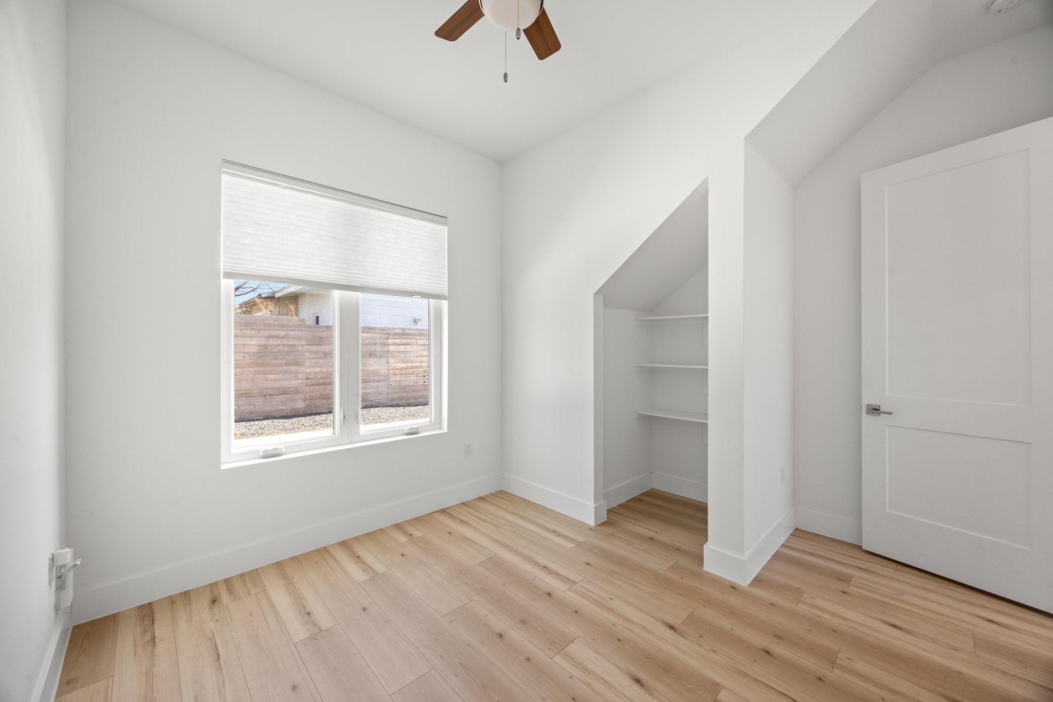 106 West Croslin Street, Unit 1 Austin, TX 78752 - Photo 16 of 31 an empty room with wooden floor and windows