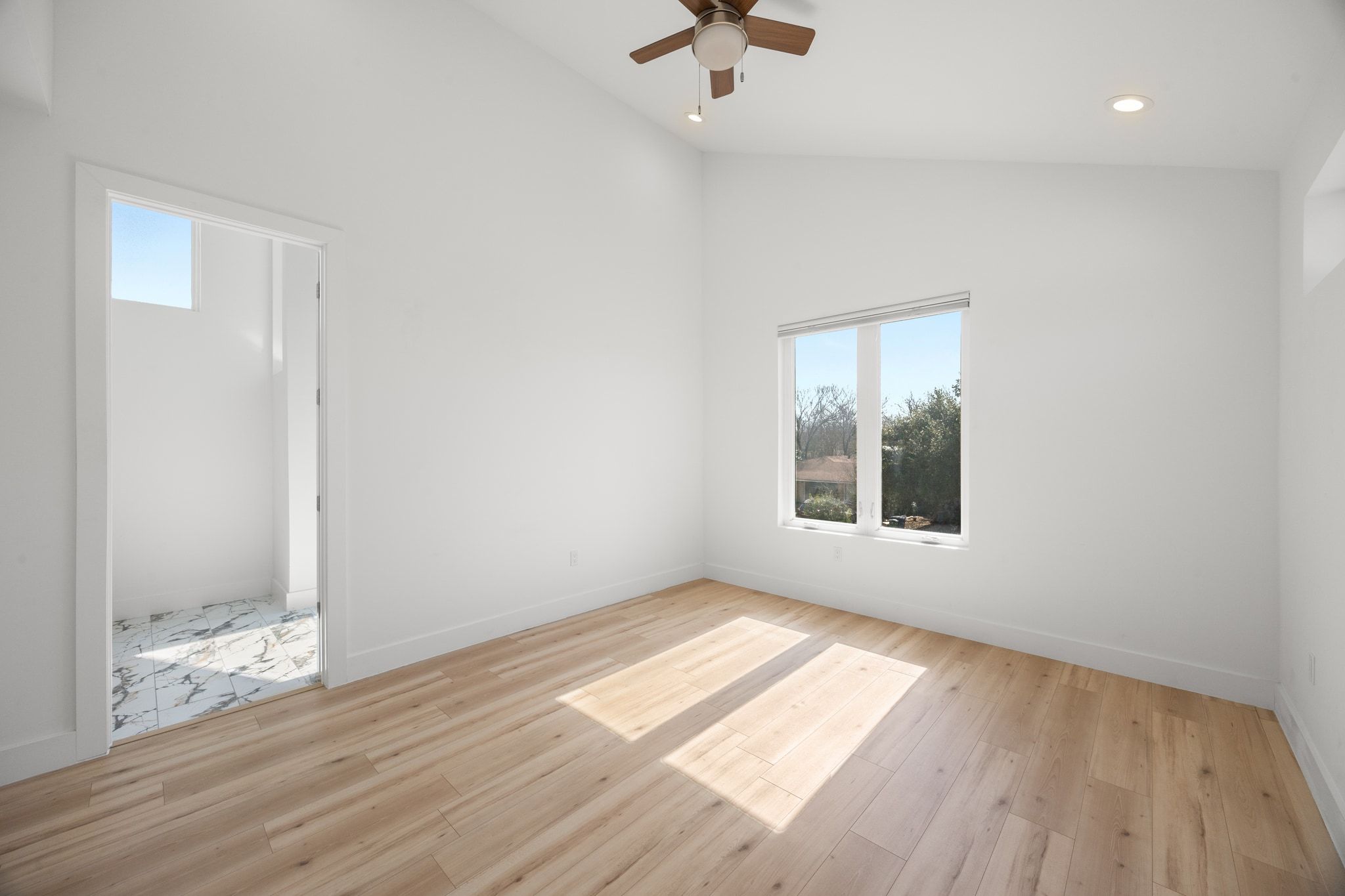 106 West Croslin Street, Unit 1 Austin, TX 78752 - Photo 27 of 31 an empty room with wooden floor and windows
