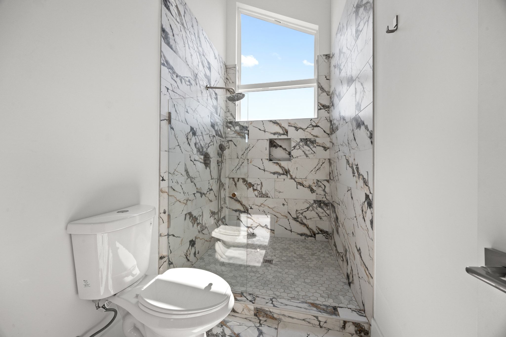 106 West Croslin Street, Unit 1 Austin, TX 78752 - Photo 29 of 31 a white toilet sitting next to a shower curtain