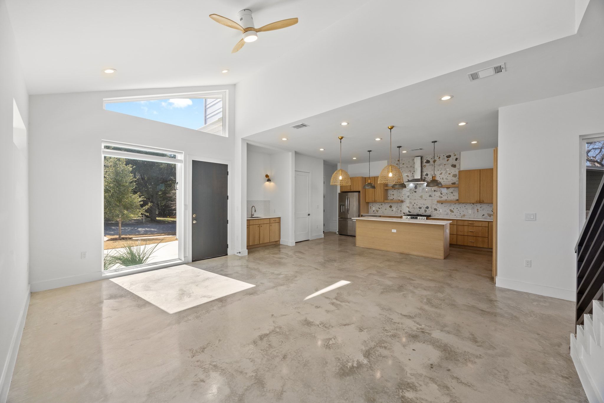 106 West Croslin Street, Unit 1 Austin, TX 78752 - Photo 5 of 31 a view of a kitchen with kitchen island a sink stainless steel appliances and cabinets