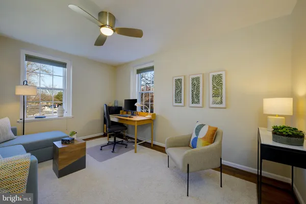 a living room with furniture and a lamp