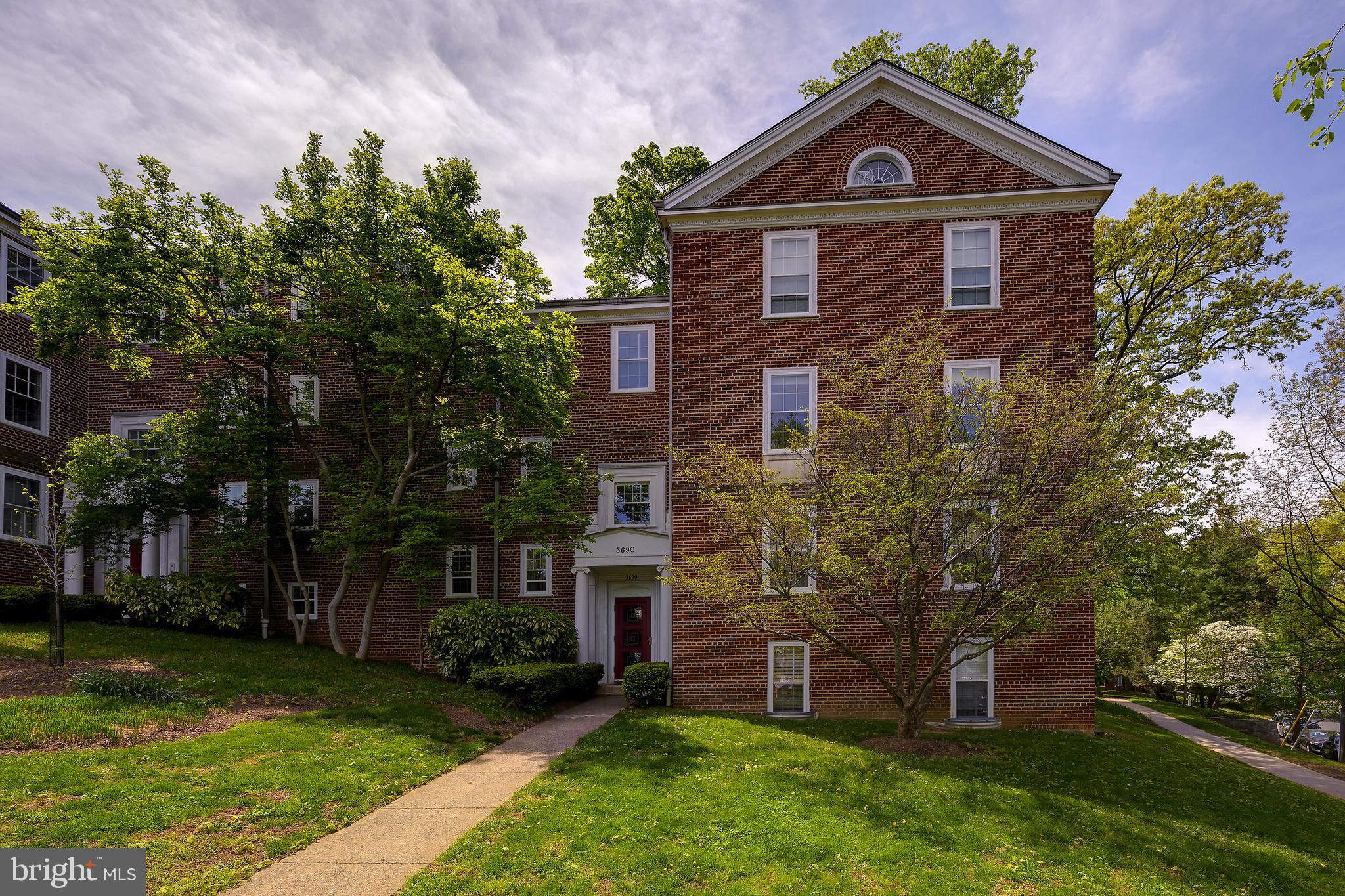 3690 38th Street Northwest, Unit C237 Washington, DC 20016 - Photo 2 of 35 a front view of a house with a yard