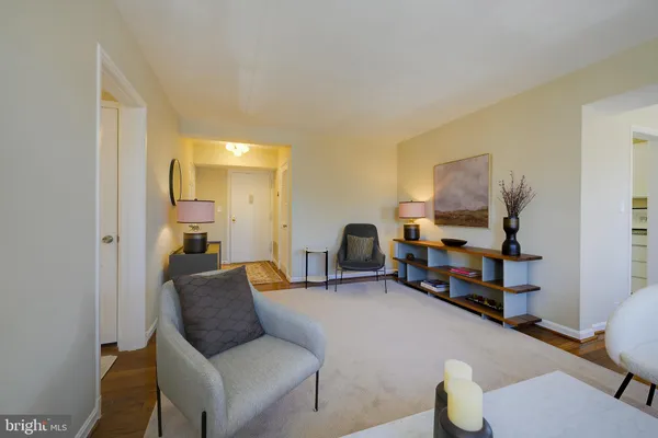 a living room with furniture and a dining table with wooden floor